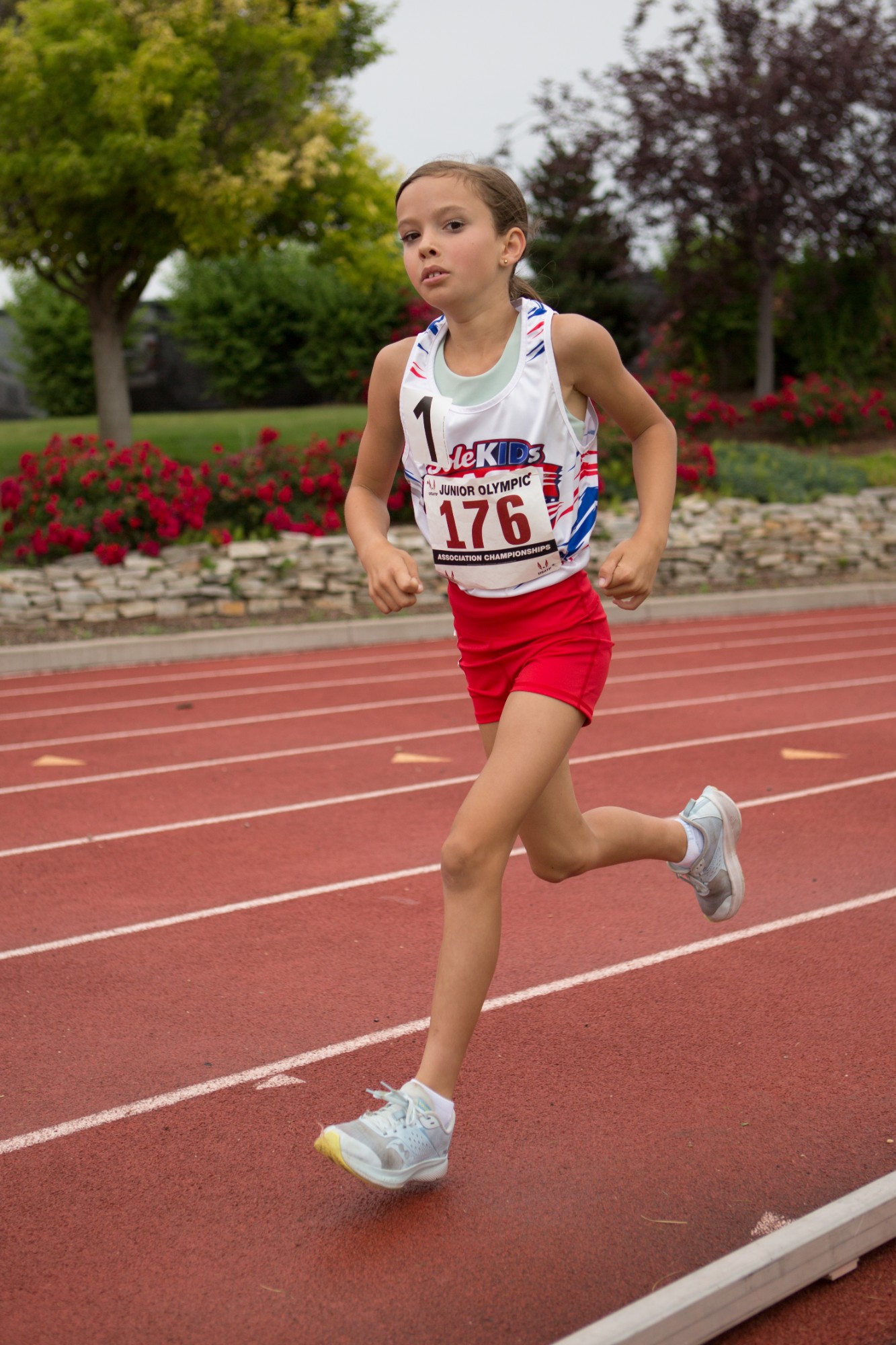 A DASH runner racing on the track wearing bib 176